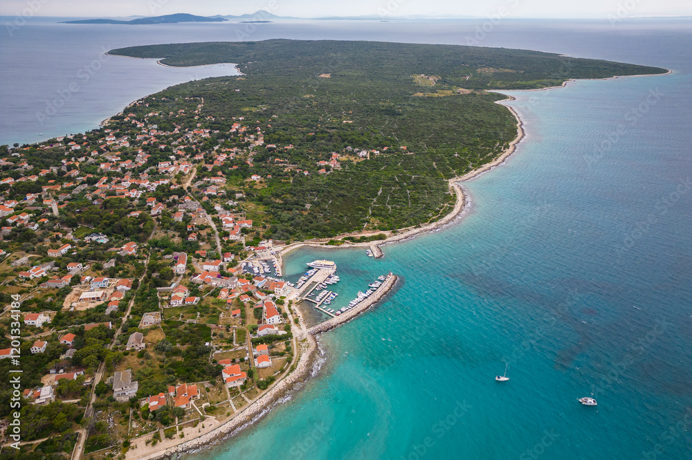 Fototapeta premium Aerial drone view of Croatian island Silba with beautiful beaches. Amazing Adriatic sea tourist vacation destination in Croatia. Panoramic paradise blue sea, sandy beaches, old houses and boats