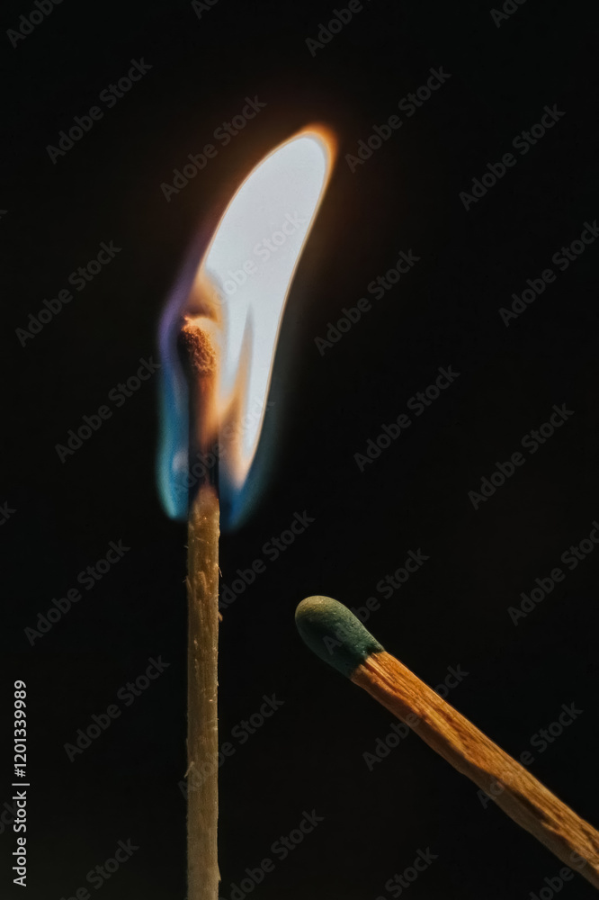 igniting matchstick with glowing flame on dark background igniting matchstick with glowing flame on dark background