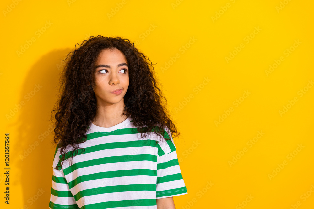 Fototapeta premium Portrait of pretty young girl look empty space wear striped t-shirt isolated on yellow color background