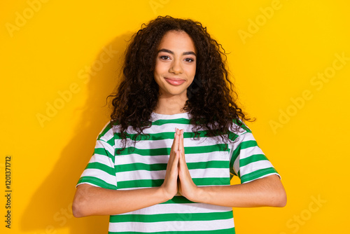 Portrait of pretty young girl arms plead wear striped t-shirt isolated on yellow color background