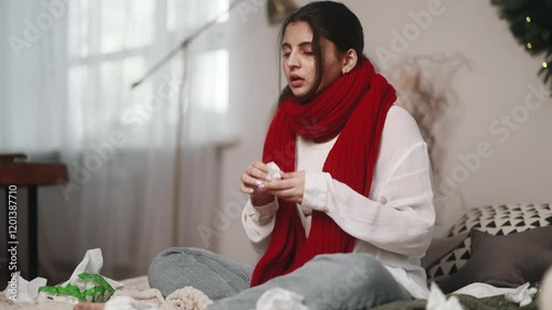 Sick unhealthy young indian woman with warm scarf coughing sneezing and having severe headache temperature at home Sad tired girl with flu virus symptom at cold season indoors