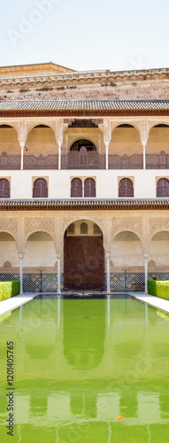 View of the Court of the Myrtles, with a large pool, located in the Comares Palace inside the Alhambra. It is one of the main monuments of Granada, Spain.