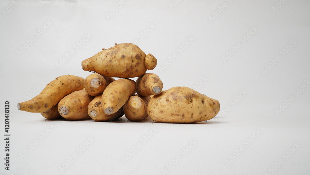 Fototapeta premium Group of fresh local raw honey sweet potatoes isolated on white background.