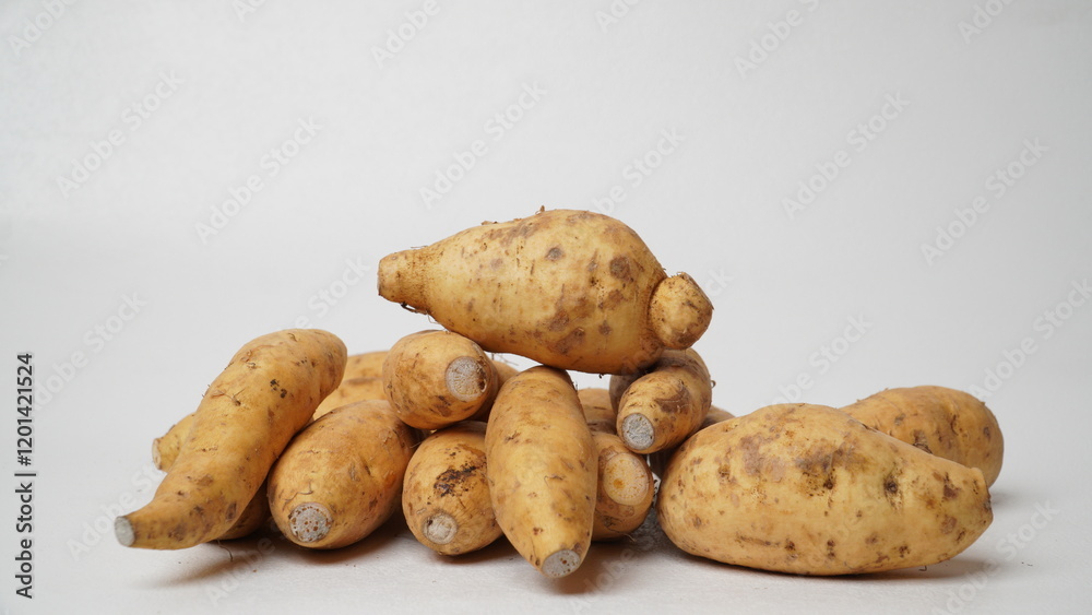 Fototapeta premium Group of fresh local raw honey sweet potatoes isolated on white background.