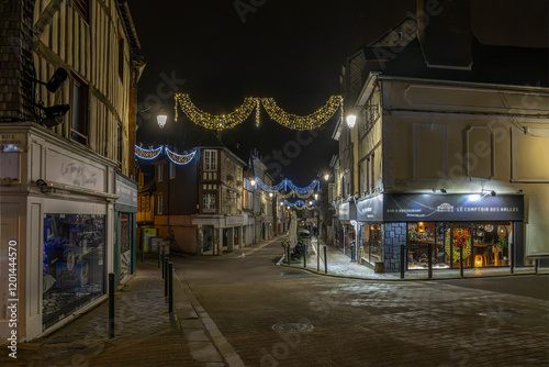 Normandy, France -12- 30- 2024 : Exterior night photo view of christmas light decorations for xmas celebrations decor evening with garlands and tinsel lights,