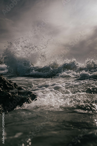 A large wave crashing into the shore
