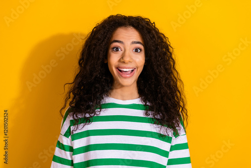 Portrait of pretty young girl open mouth cant believe wear striped t-shirt isolated on yellow color background photo