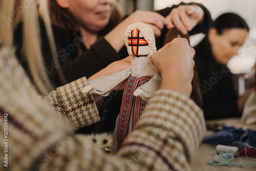 Ukrainian traditional Motanka doll in national costume. Master class on making traditional symbol. Nation code. Cultural heritage. Craft amulet. Patriotic handicrafts. Soft focus photo