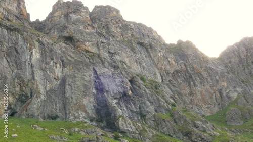 Panning shot on the Paradise Rocks to the Raisko Praskalo waterfall. It is the highest waterfall in Bulgaria. Located near Botev Peak and Kalofer town. Water from melted snow flows down the rocks. photo