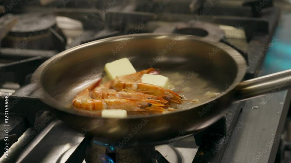 Chef Putting Butter On Shrimps On Frying Pan. - closeup shot Chef Putting Butter On Shrimps On Frying Pan. - closeup shot