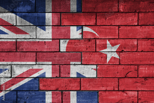 Fototapeta Naklejka Na Ścianę i Meble -  colourful painted big flag of great britain and flag of turkey on a massive old brick wall background. concept