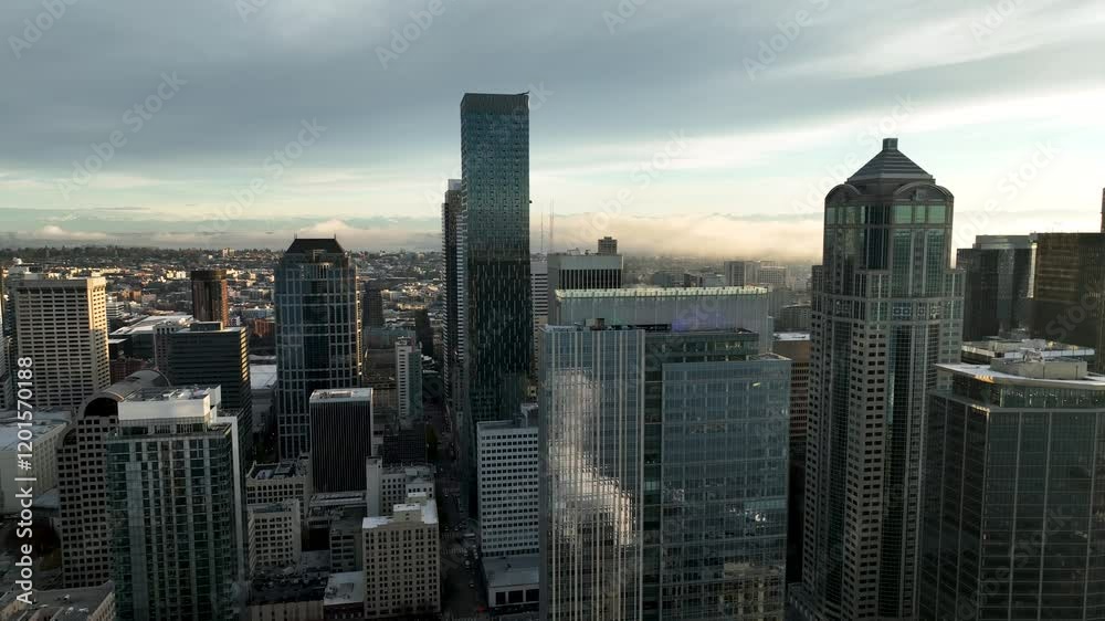 Lowering aerial of Seattle skyscrapers reflecting Elliot Bay and steam billows on windows Lowering aerial of Seattle skyscrapers reflecting Elliot Bay and steam billows on windows