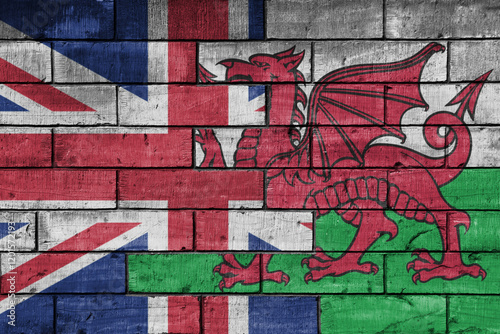 colourful painted big flag of great britain and flag of wales on a massive old brick wall background. concept photo