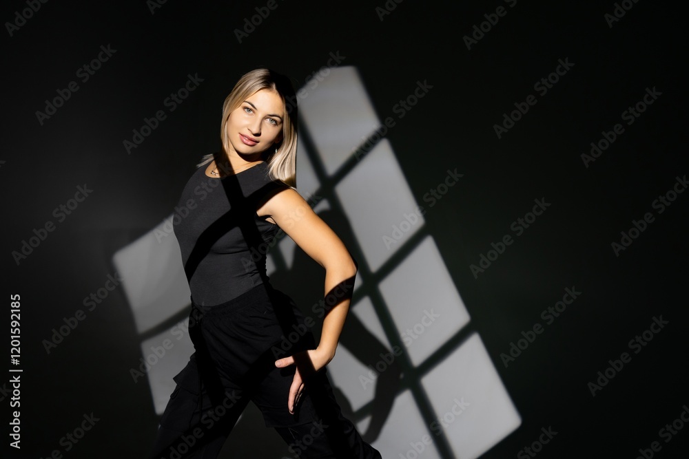 Fototapeta premium Young dancer performing with window-shaped shades on background
