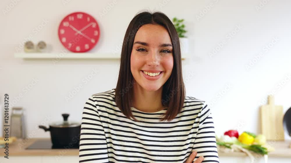 Portrait of young happy beautiful woman smiling at the camera sitting at kitchen table Portrait of young happy beautiful woman smiling at the camera sitting at kitchen table