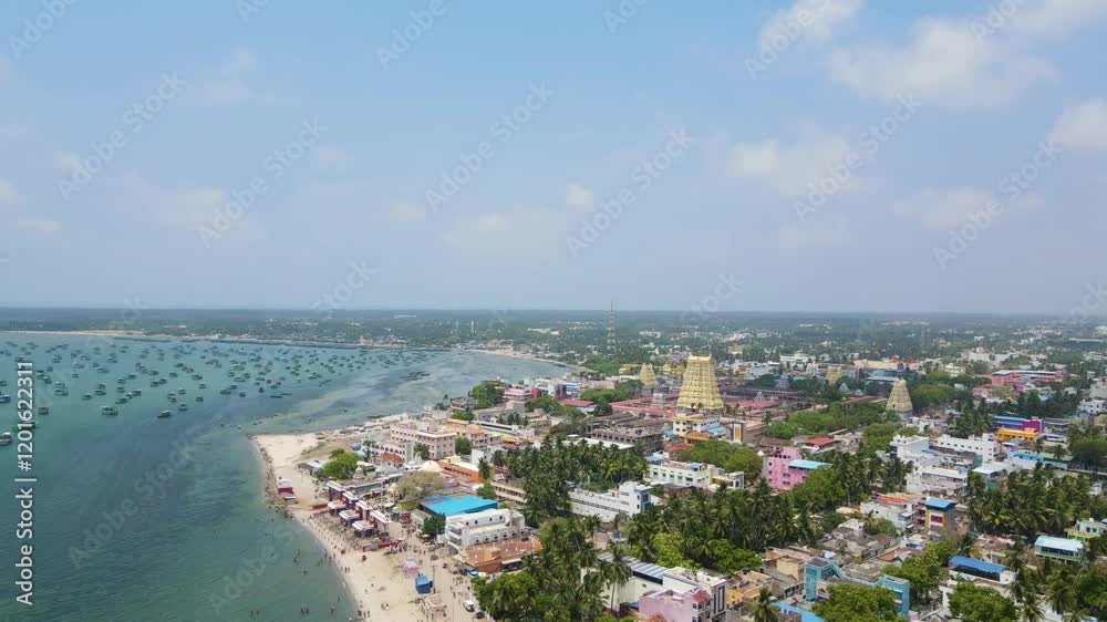 Aerial drone shot showcasing the iconic Rameshwaram temple surrounded by the vibrant city. Aerial drone shot showcasing the iconic Rameshwaram temple surrounded by the vibrant city.