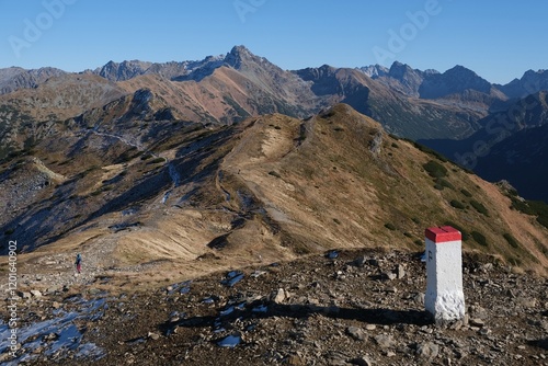 Scenery of autumn Tatras Mountains with white and red border post Poland Slovakia. Czerwone Wierchy range from around Kasprowy Wierch Peak, Tatras Mountains, Poland.  