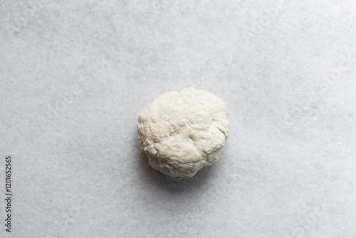 Overhead view of chinese scallion pancake dough on white countertop, top view of homemade scallion pancake dough, process of making cong you bing photo