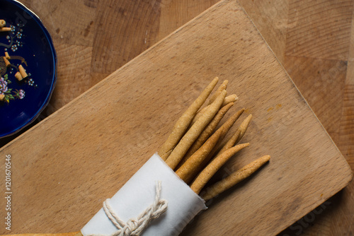 Top view of fried corn stick snack on a wood board, Overhead view of nigerian kokoro corn snack photo