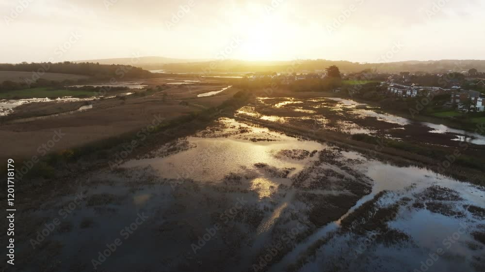A beautiful sunset over a field with a river running through it. The sky is filled with a warm orange glow, and the water is calm and still. The scene is peaceful and serene A beautiful sunset over a field with a river running through it. The sky is filled with a warm orange glow, and the water is calm and still. The scene is peaceful and serene