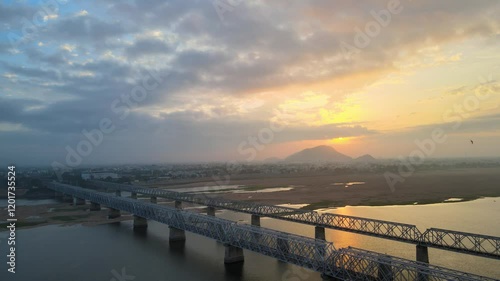 Wallpaper Mural Picturesque aerial drone shot of Vijayawada at dawn, with the golden sunrise reflecting on the city’s river and buildings. Torontodigital.ca