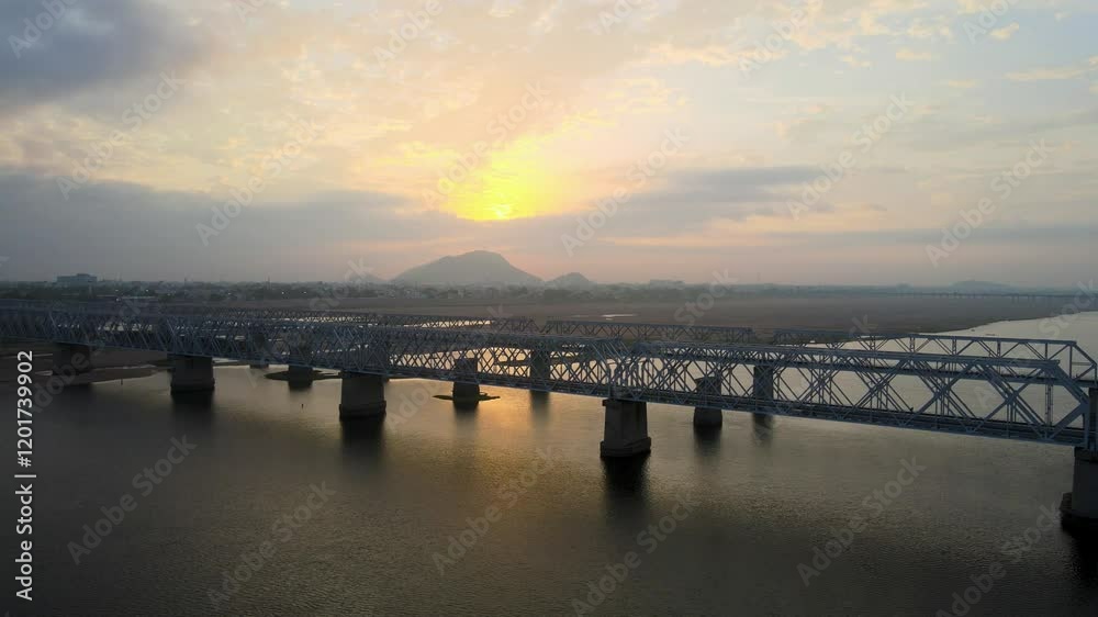 Majestic aerial drone shot of Vijayawada city during sunrise, with a view soaring above the scattered clouds. Majestic aerial drone shot of Vijayawada city during sunrise, with a view soaring above the scattered clouds.
