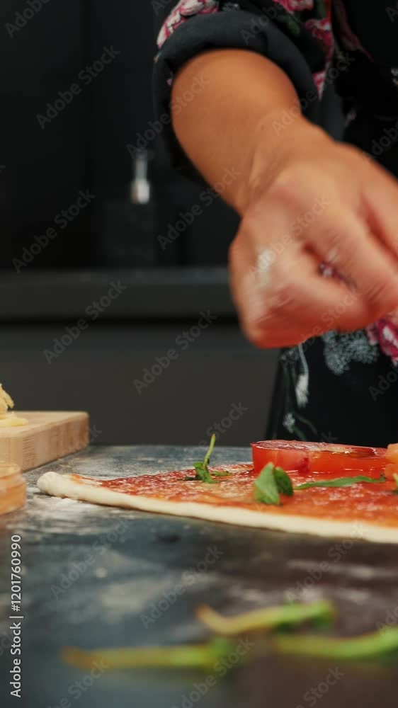 Woman preparing tasty pizza at home, adding fish to pizza base. Vertical video Woman preparing tasty pizza at home, adding fish to pizza base. Vertical video