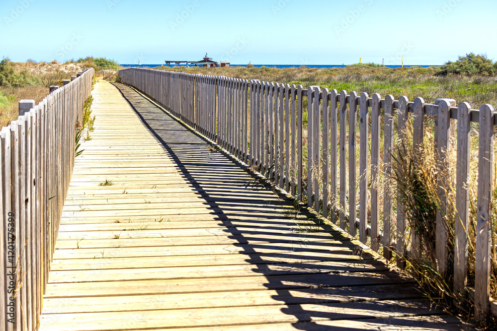 wooden bridge over the dunes on the beach road