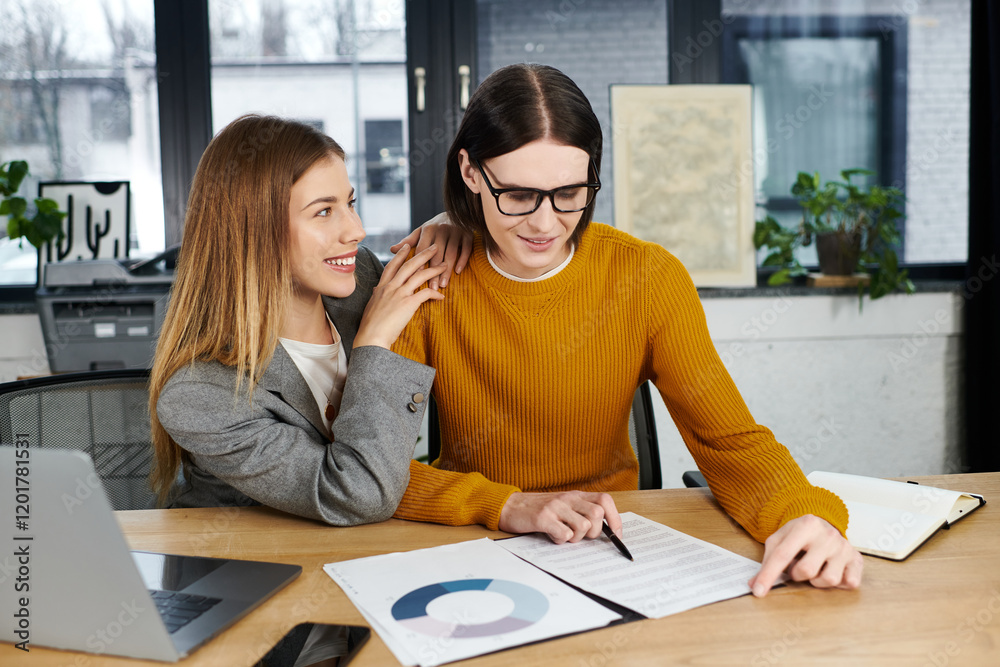 Two young individuals engage in creative collaboration at a stylish workspace while sharing ideas. Two young individuals engage in creative collaboration at a stylish workspace while sharing ideas.
