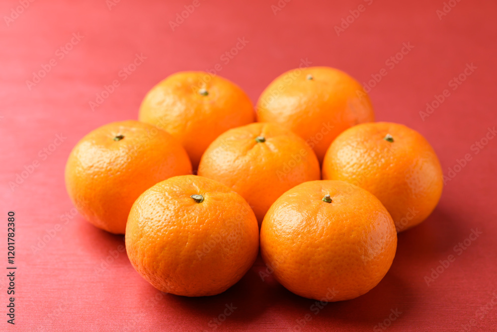 Mandarin tangerine orange fruit on red background, Lucky food in Lunar New Year or Chinese New Year Mandarin tangerine orange fruit on red background, Lucky food in Lunar New Year or Chinese New Year