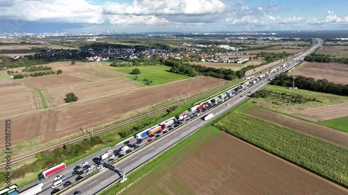 Hochheim, Germany - October 02, 2024: German highway A 3 nearby Wiesbadener Kreuz. Large traffic jam due to rush hour traffic - aerial view