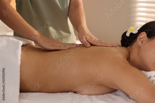 Woman receiving massage in spa salon, closeup photo