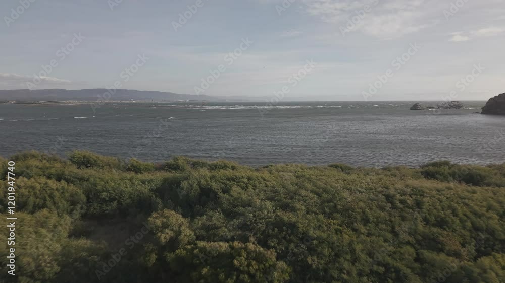 A scenic aerial view of the Río Biobío mouth near Concepción, Chile, where the river meets the ocean. Coastal landscapes, dynamic water movement, and natural beauty captured in cinematic quality A scenic aerial view of the Río Biobío mouth near Concepción, Chile, where the river meets the ocean. Coastal landscapes, dynamic water movement, and natural beauty captured in cinematic quality