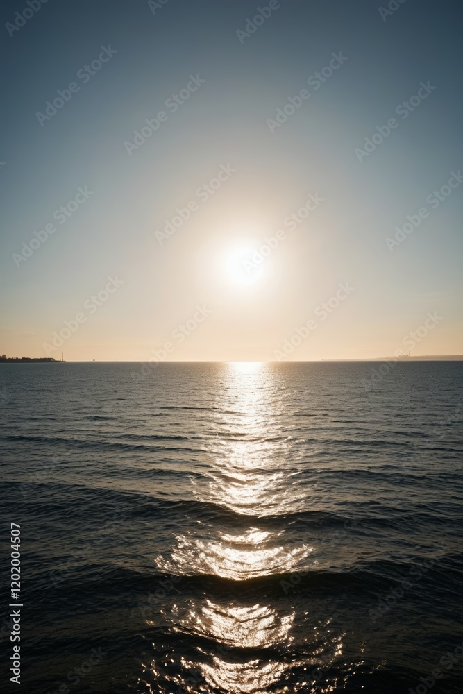 Obraz premium arafed view of the sun setting over the ocean with a boat in the distance