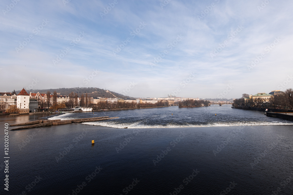 Fototapeta premium Vltava river flowing showing prague castle on sunny day