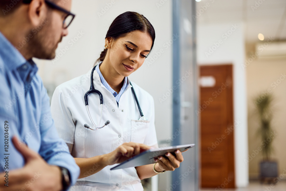 Doctor Discussing Medical Information with Patient Using a Digital Device Doctor Discussing Medical Information with Patient Using a Digital Device