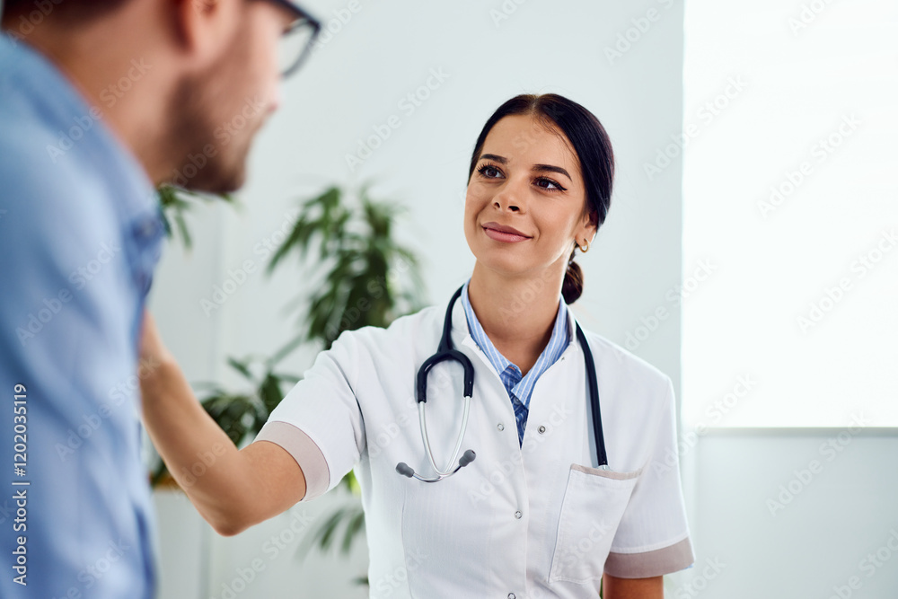 Smiling Doctor Conversing with a Patient in a Bright Medical Office Smiling Doctor Conversing with a Patient in a Bright Medical Office