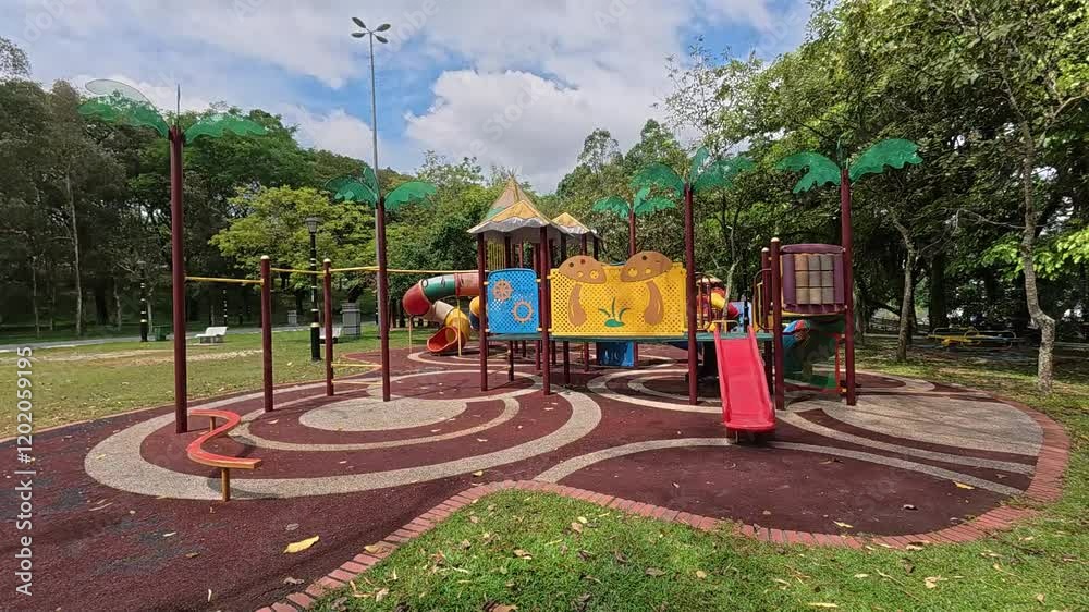 A vibrant public playground for children in a beautiful tropical park. Sunny weather enhances the cheerful outdoor atmosphere A vibrant public playground for children in a beautiful tropical park. Sunny weather enhances the cheerful outdoor atmosphere
