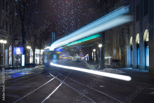 City Tram at Night with Light Trails in Long Exposure in Bahnhofstrasse in Zurich, Switzerland.