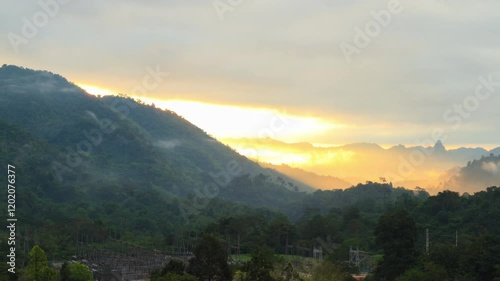 Landscape during sunrise of mountains and sky. 4K 3840x2160, wide shot and tilt up. Can be establishing shot. Time lapse.
