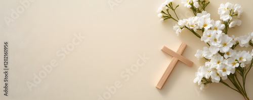 Christian background with golden crucifix on neutral beige pink wall background decorated with branches of white flowers.