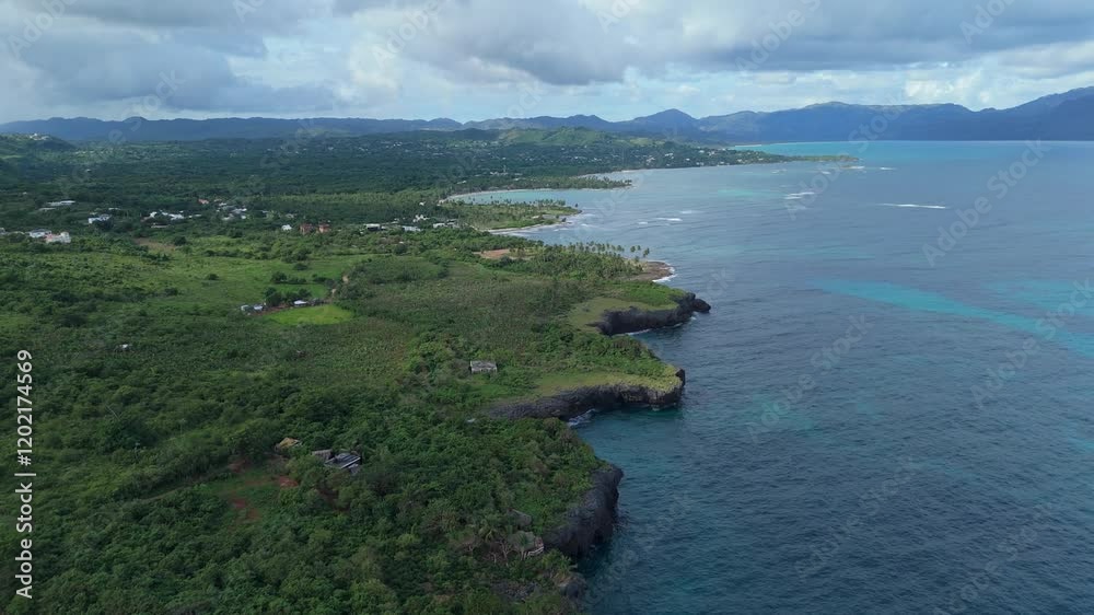 Caribbean landscape, jagged coast and cliffs along tropical sea, Las Galeras, Samana in Dominican Republic. Aerial forward