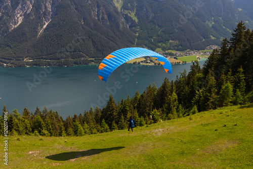 paraglider flyying in the alps at Achensee in austria  photo