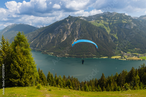 paraglider flyying in the alps at Achensee in austria  photo