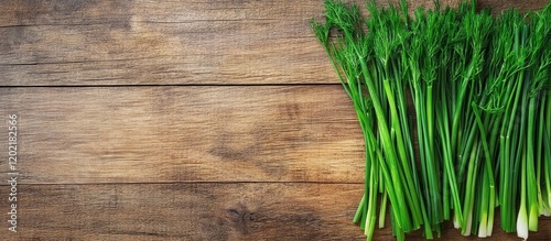 Fresh green onions on a rustic wooden background with ample copy space for text or design elements. photo