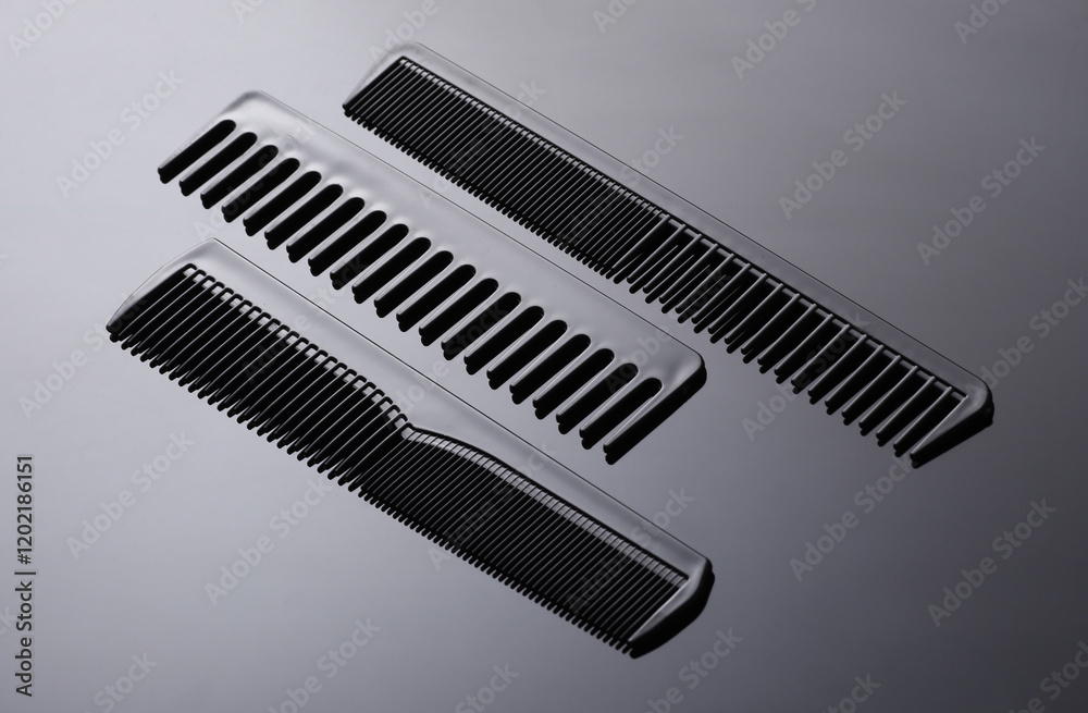Set of plastic combs on black background close-up Set of plastic combs on black background close-up