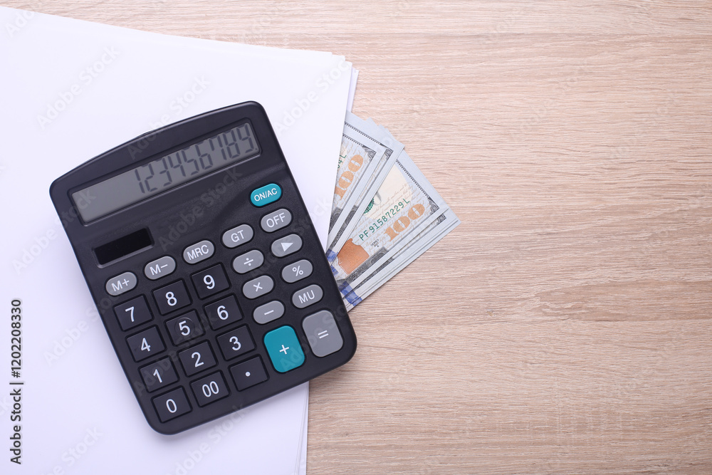 Black classic calculator with dollar bills and paper sheets on table. Business concept. Top view Black classic calculator with dollar bills and paper sheets on table. Business concept. Top view