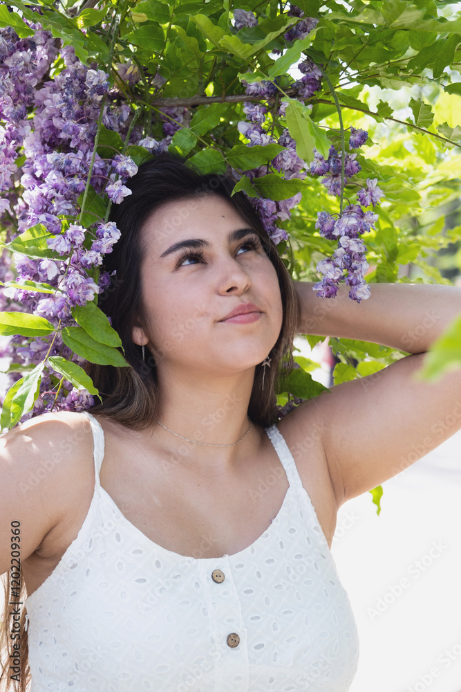 woman in a blooming wisteria garden, around flowers woman in a blooming wisteria garden, around flowers