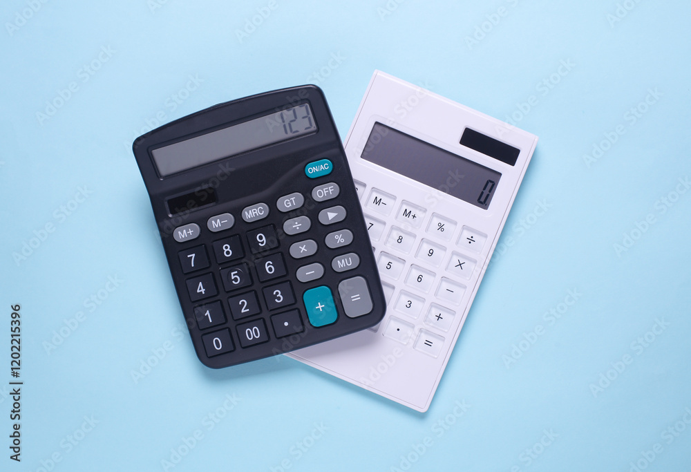 White and black calculator on blue background White and black calculator on blue background