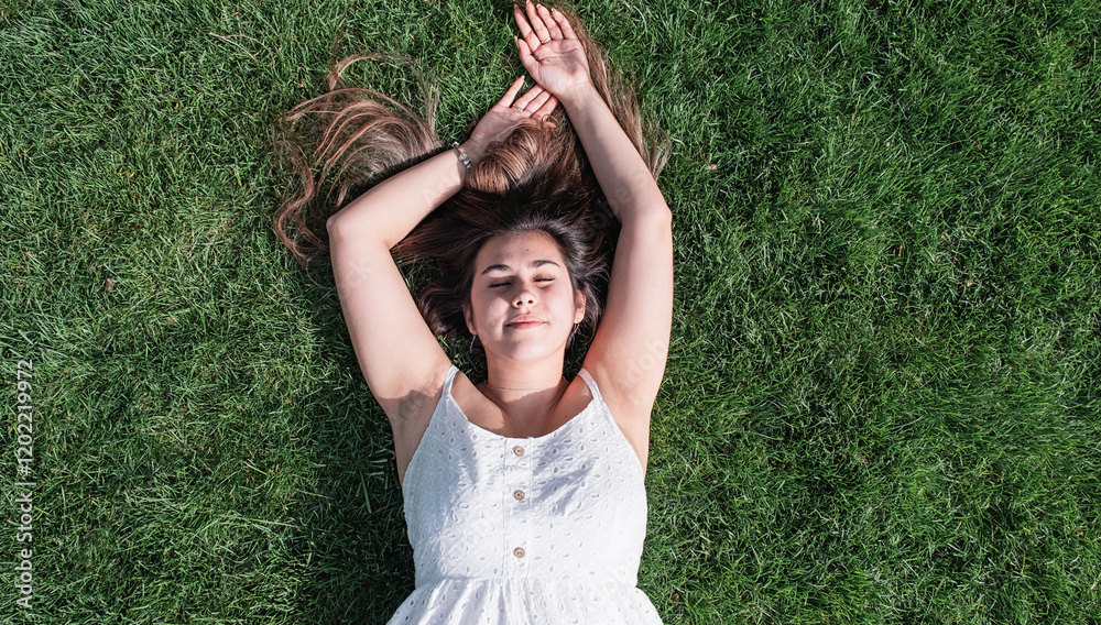 pretty young woman lying on green grass pretty young woman lying on green grass